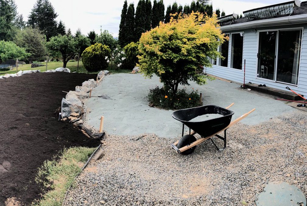 Raising a sloped back yard for a patio and play area